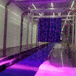 Interior shot of the car wash with purple lights